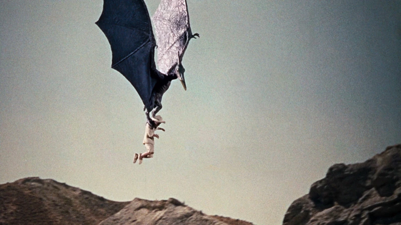 ein fliegender Saurier hat einen Cowboy gepackt